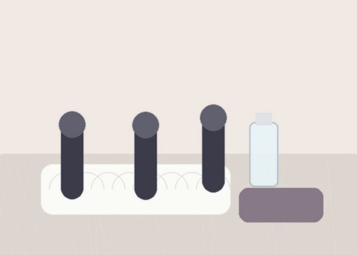 An automatic oral-style toy with its sleeve, towel, and cleaner arranged for a tube-and-air-channel cleaning guide.