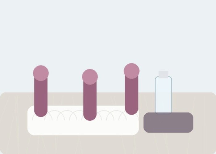 A set of vibrators with different curves laid beside lubricant for a guide to neck flex and tip width.
