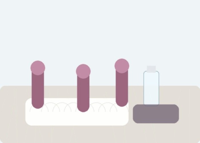 Several small oral-style toys on soft bedding to compare shape, contact area, and noise expectations.