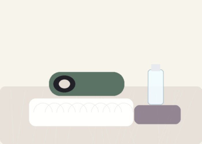 A clean male toy stored beside a pouch and towel to show a drying-first care routine.