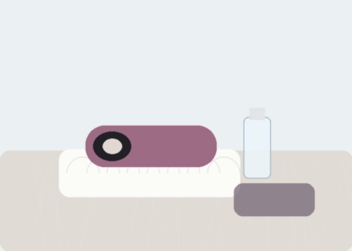 A male sex toy, towel, and cleaner arranged for a pocket pussy odor troubleshooting guide.