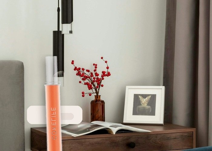 A calm bedside setup with pillows and lubricant to support angle and comfort during the pretzel dip position.