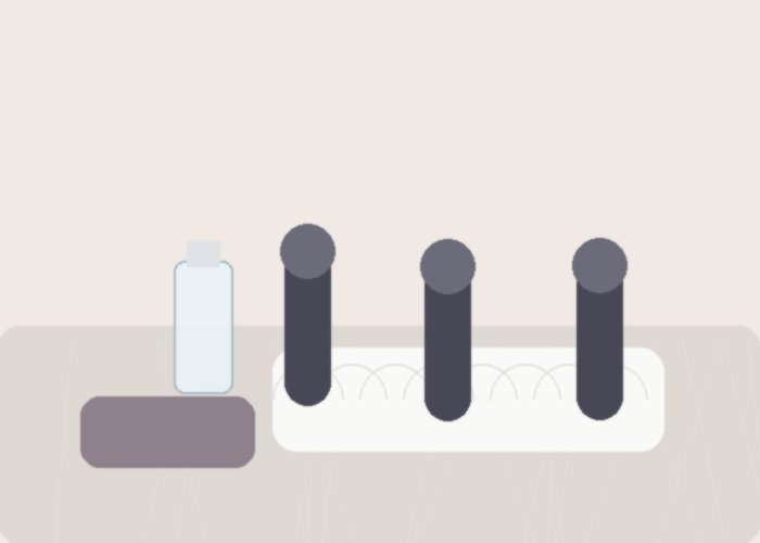 A purple vibrator and lubricant arranged on a bed for checking comfort and pressure.