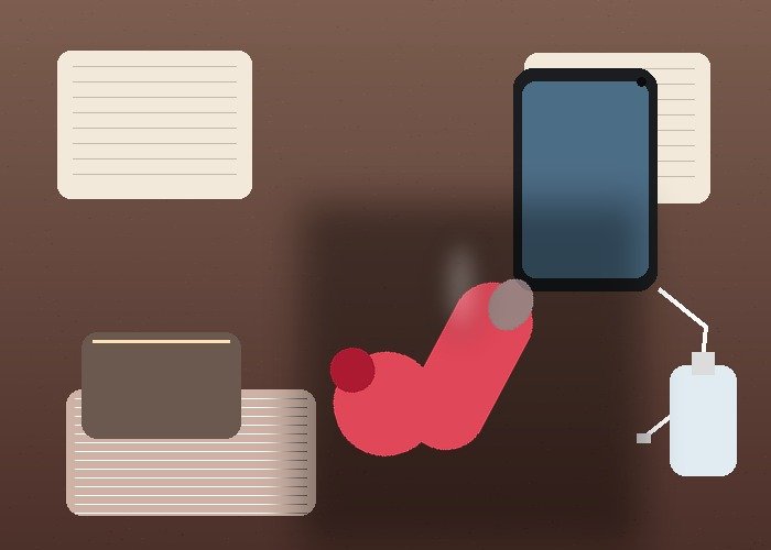 A realistic remote-intimacy setup with a phone, compact vibrator, charger, earbuds, and notebook arranged on a bedside table.